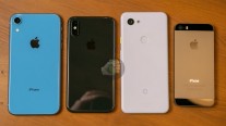 Pixel 3 lite next to iPhone XR (blue), XS (black) and 5s (space gray)