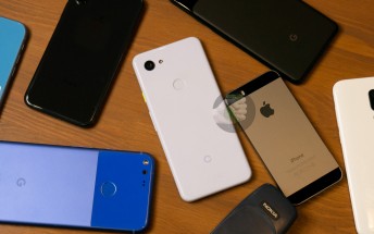 Google Pixel 3 lite photographed next to original Pixel, several iPhones