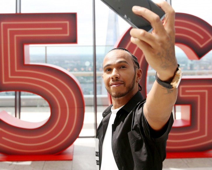 F1 legend Lewis Hamilton taking a selfie for Vodafone