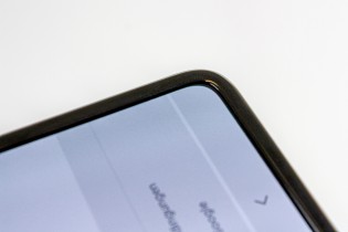 The protective layer extends beyond the edges of the screen