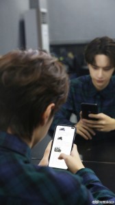 A candid photo of Wang Yibo holding the Redmi K30