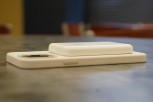 Apple MagSafe battery pack on an iPhone with a white silicone case