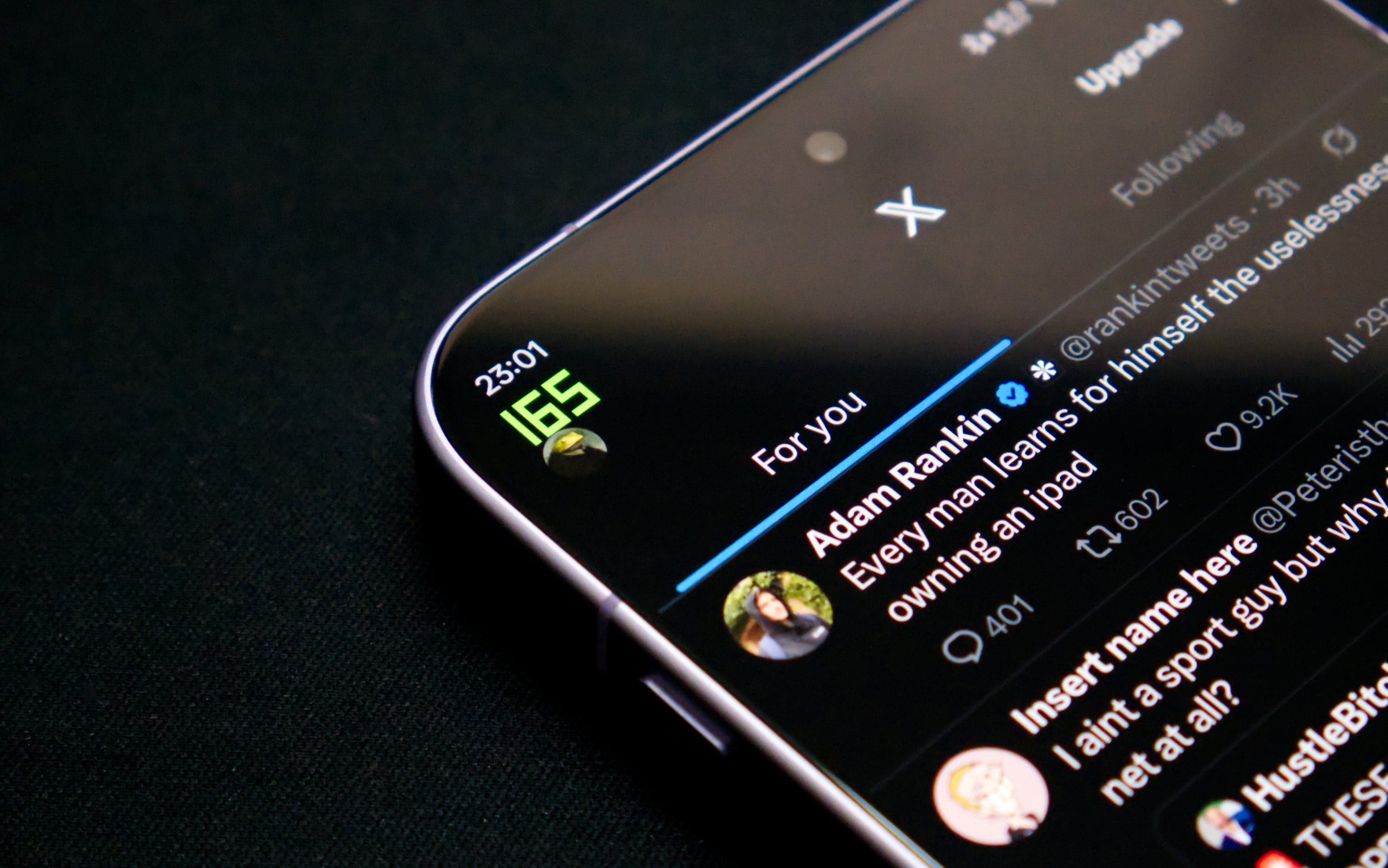 A close-up shot of the OnePlus 15 smartphone display, prominently showcasing its vibrant screen running a social media application like Instagram or X at a high refresh rate. The fluidity of scrolling is implied, emphasizing the advanced visual capabilities of the 165Hz display for an enhanced user experience, with a subtle focus on the phone's sleek design.